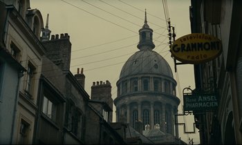 Movie still from “Muriel” (1963), directed by Alain Resnais – A very tall building with a very large dome in it; Extreme Wide shot, Low angle