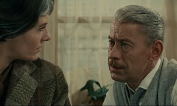 Movie still from “Muriel” (1963), directed by Alain Resnais – A man and a woman are looking at each other; Close Up shot, Over the shoulder angle