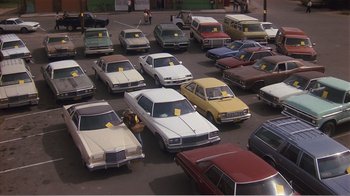Movie still from “Murphy's Romance” (1985), directed by Martin Ritt – A parking lot filled with lots of parked cars; Extreme Wide shot, High angle