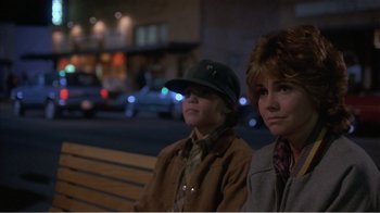 Movie still from “Murphy's Romance” (1985), directed by Martin Ritt – A couple of people sitting on top of a wooden bench; Close Up shot, Low angle