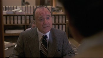 Movie still from “Murphy's Romance” (1985), directed by Martin Ritt – An older man wearing a suit and tie in front of a woman; Close Up shot, Over the shoulder angle