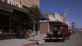 Movie still from “Murphy's Romance” (1985), directed by Martin Ritt – An old car parked on the side of the street; Wide shot, Low angle