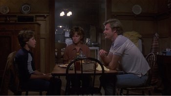 Movie still from “Murphy's Romance” (1985), directed by Martin Ritt – A group of people sitting at a dinner table; Medium shot, Over the shoulder angle