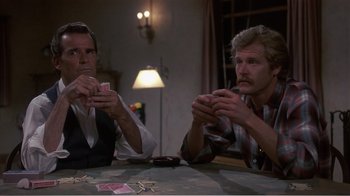 Movie still from “Murphy's Romance” (1985), directed by Martin Ritt – Two men sitting at a table with cards in their hands; Medium shot, Over the shoulder angle