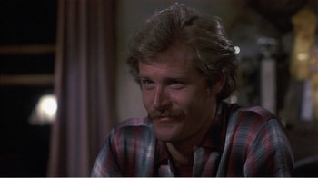 Movie still from “Murphy's Romance” (1985), directed by Martin Ritt – A person wearing a plaid shirt; Close Up shot, High angle