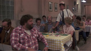 Movie still from “Murphy's Romance” (1985), directed by Martin Ritt – A group of people sitting around a table; Medium shot, Over the shoulder angle