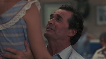 Movie still from “Murphy's Romance” (1985), directed by Martin Ritt – An older man looking up at a young woman; Close Up shot, Over the shoulder angle