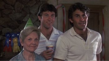 Movie still from “Murphy's Romance” (1985), directed by Martin Ritt – A group of people standing next to each other holding drinks; Close Up shot, Low angle