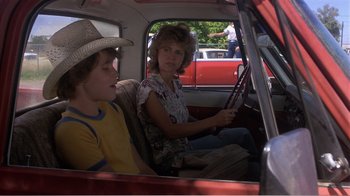 Movie still from “Murphy's Romance” (1985), directed by Martin Ritt – A woman and a boy sitting in the back of a truck; Medium shot, Over the shoulder angle