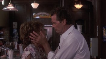 Movie still from “Murphy's Romance” (1985), directed by Martin Ritt – An older man and a younger woman touching their faces; Close Up shot, Over the shoulder angle