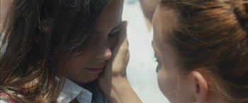 Movie still from “Mustang” (2015), directed by Deniz Gamze Ergüven – A person holding another person's face; Extreme Close Up shot, Over the shoulder angle