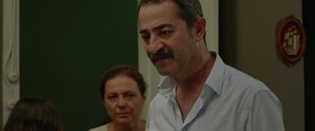 Movie still from “Mustang” (2015), directed by Deniz Gamze Ergüven – A man and a woman are looking at the camera; Close Up shot, Over the shoulder angle