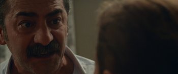 Movie still from “Mustang” (2015), directed by Deniz Gamze Ergüven – An older man looking at a younger man in the mirror; Extreme Close Up shot, Over the shoulder angle