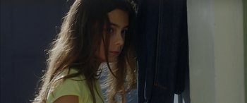 Movie still from “Mustang” (2015), directed by Deniz Gamze Ergüven – A young girl with long dark hair looking at the camera; Close Up shot, Low angle