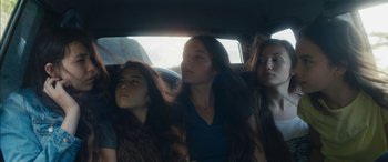Movie still from “Mustang” (2015), directed by Deniz Gamze Ergüven – Three young women sitting in the back seat of a car; Medium shot, Low angle