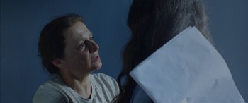 Movie still from “Mustang” (2015), directed by Deniz Gamze Ergüven – An older woman looking at a younger woman in front of a blue wall; Close Up shot, Over the shoulder angle