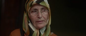 Movie still from “Mustang” (2015), directed by Deniz Gamze Ergüven – An older woman wearing glasses and a head scarf; Close Up shot, Over the shoulder angle