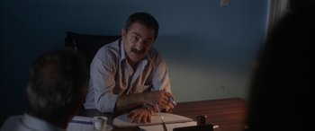Movie still from “Mustang” (2015), directed by Deniz Gamze Ergüven – A man sitting at a table with a pen and paper; Medium shot, High angle