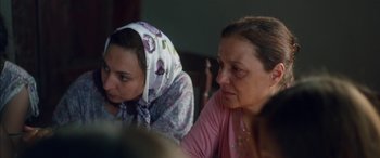 Movie still from “Mustang” (2015), directed by Deniz Gamze Ergüven – Two women are sitting at a table and one of the women is wearing a scarf; Close Up shot, Over the shoulder angle