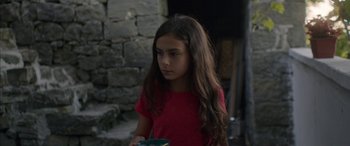 Movie still from “Mustang” (2015), directed by Deniz Gamze Ergüven – A girl in a red shirt is looking at the camera; Close Up shot, Over the shoulder angle