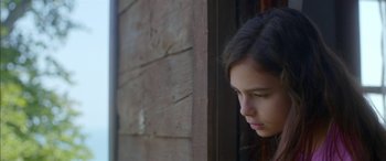 Movie still from “Mustang” (2015), directed by Deniz Gamze Ergüven – A young woman looking out a window with her eyes wide open; Close Up shot, Low angle