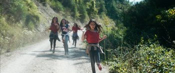 Movie still from “Mustang” (2015), directed by Deniz Gamze Ergüven – A group of young girls running down a dirt road; Wide shot, High angle