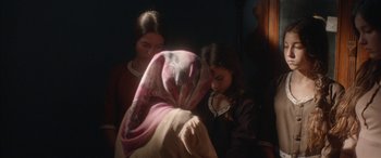 Movie still from “Mustang” (2015), directed by Deniz Gamze Ergüven – Two young women are looking at a scarf; Medium shot, Over the shoulder angle