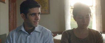 Movie still from “Mustang” (2015), directed by Deniz Gamze Ergüven – A man and a woman sitting in front of each other in a room; Close Up shot, Over the shoulder angle