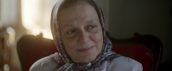 Movie still from “Mustang” (2015), directed by Deniz Gamze Ergüven – An older woman wearing a head scarf looking at the camera; Close Up shot, Over the shoulder angle