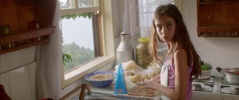 Movie still from “Mustang” (2015), directed by Deniz Gamze Ergüven – A young girl sitting at a table in front of a bowl of cereal; Medium shot, Over the shoulder angle