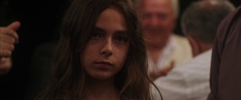 Movie still from “Mustang” (2015), directed by Deniz Gamze Ergüven – A young girl with long brown hair looking at the camera; Close Up shot, Over the shoulder angle