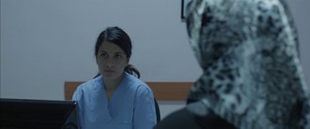 Movie still from “Mustang” (2015), directed by Deniz Gamze Ergüven – A woman wearing a blue shirt and a black and white head scarf; Close Up shot, Over the shoulder angle