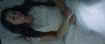 Movie still from “Mustang” (2015), directed by Deniz Gamze Ergüven – A woman in a white dress laying on a bed; Close Up shot, Overhead angle