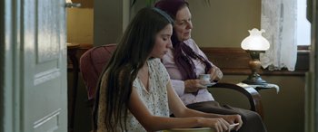 Movie still from “Mustang” (2015), directed by Deniz Gamze Ergüven – A woman and a young girl sitting next to each other; Medium shot, Over the shoulder angle