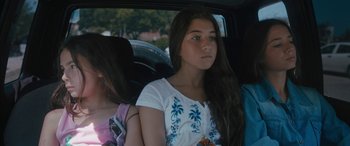 Movie still from “Mustang” (2015), directed by Deniz Gamze Ergüven – Two young girls sitting in the back seat of a car; Close Up shot, Over the shoulder angle