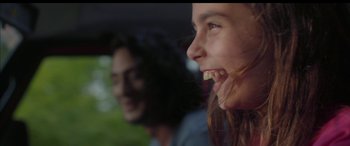 Movie still from “Mustang” (2015), directed by Deniz Gamze Ergüven – Two people are smiling while sitting in a car; Close Up shot, Low angle