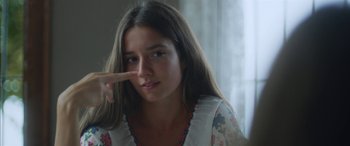 Movie still from “Mustang” (2015), directed by Deniz Gamze Ergüven – A woman with long hair is making a face; Close Up shot, Over the shoulder angle