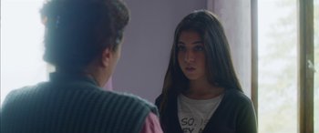 Movie still from “Mustang” (2015), directed by Deniz Gamze Ergüven – A young girl looking into a mirror while a young man looks on; Close Up shot, Over the shoulder angle