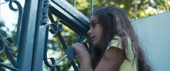 Movie still from “Mustang” (2015), directed by Deniz Gamze Ergüven – A young girl leaning against a metal fence; Close Up shot, Low angle