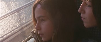 Movie still from “Mustang” (2015), directed by Deniz Gamze Ergüven – A young girl looking out of a window at the sun; Close Up shot, High angle