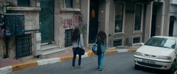 Movie still from “Mustang” (2015), directed by Deniz Gamze Ergüven – Two girls walking down the street in front of a building; Wide shot, Low angle