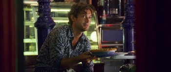 Movie still from “My Blueberry Nights” (2007), directed by Kar-Wai Wong – A man sitting in front of a bowl of food; Medium shot, Over the shoulder angle