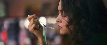 Movie still from “My Blueberry Nights” (2007), directed by Kar-Wai Wong – A person holding a spoon in her mouth; Close Up shot, Over the shoulder angle