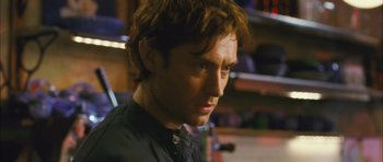 Movie still from “My Blueberry Nights” (2007), directed by Kar-Wai Wong – A person wearing a black shirt; Close Up shot, Over the shoulder angle