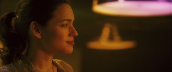 Movie still from “My Blueberry Nights” (2007), directed by Kar-Wai Wong – A woman's face in a dimly - lit room; Close Up shot, Over the shoulder angle
