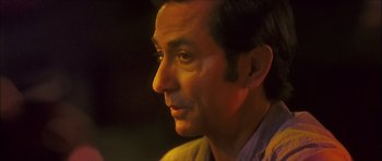 Movie still from “My Blueberry Nights” (2007), directed by Kar-Wai Wong – A man's face in the dark; Close Up shot, Over the shoulder angle