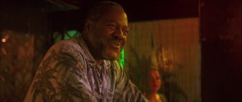 Movie still from “My Blueberry Nights” (2007), directed by Kar-Wai Wong – A person sitting at a table; Close Up shot, Low angle