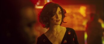 Movie still from “My Blueberry Nights” (2007), directed by Kar-Wai Wong – A beautiful woman with short brown hair wearing a black dress; Close Up shot, Over the shoulder angle