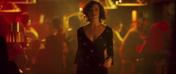 Movie still from “My Blueberry Nights” (2007), directed by Kar-Wai Wong – A woman in a black dress standing next to a crowd of onlookers; Medium shot, Low angle