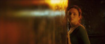 Movie still from “My Blueberry Nights” (2007), directed by Kar-Wai Wong – A woman standing next to a wall looking at the camera; Close Up shot, Low angle